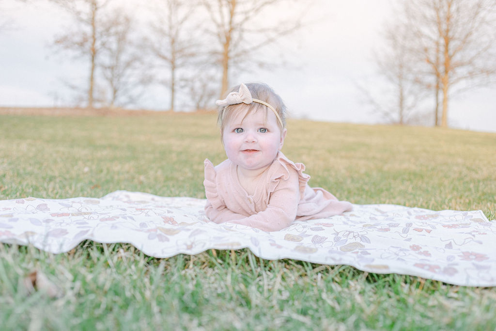 6 month old baby girl poses outside for milestone family photography session, dayton ohio lifestyle photography