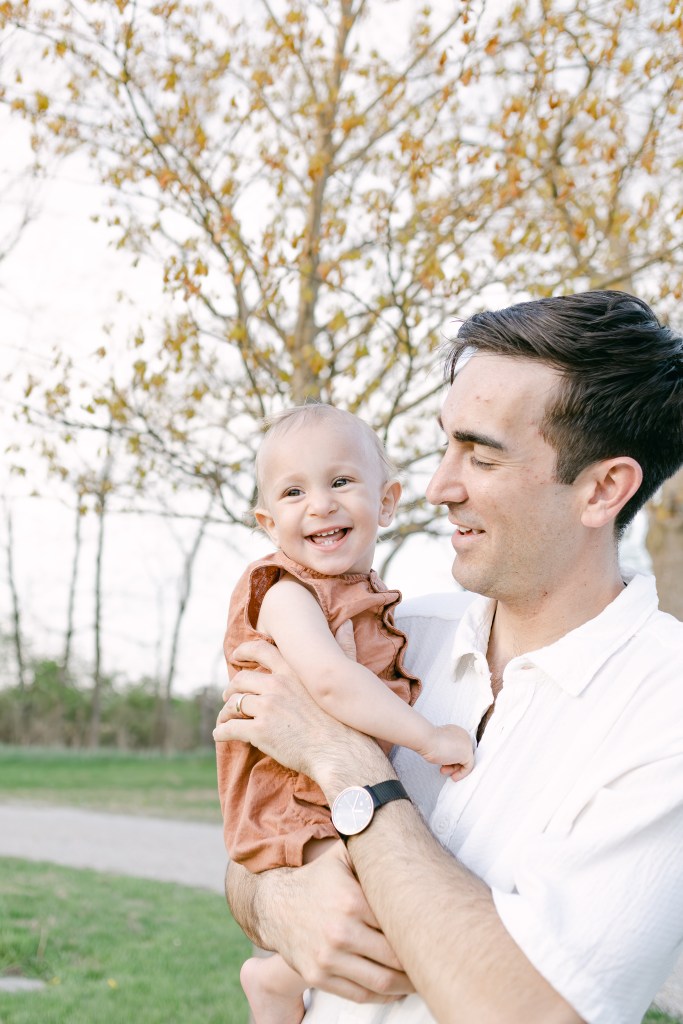 father looks at young smiling son 